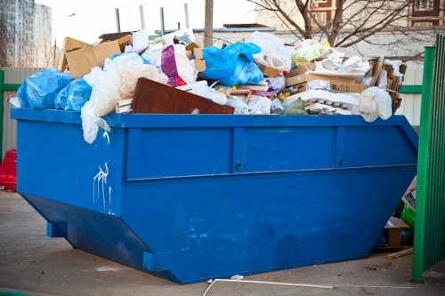 Professional waste removal team collecting business waste from a commercial building.